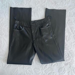 Black vintage leather pants with white contrast stitching.